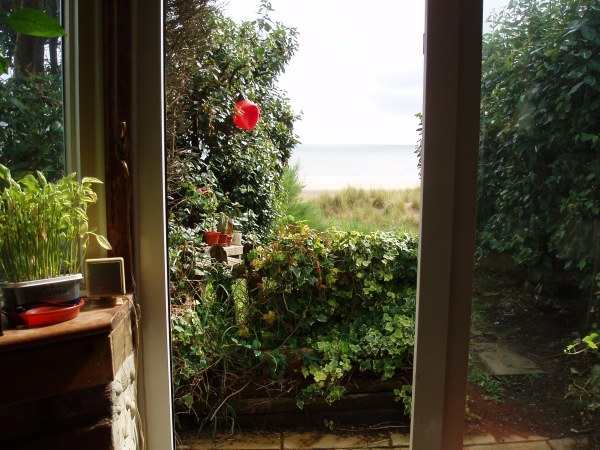 The beach room leads into the front garden and onto the sandy beach